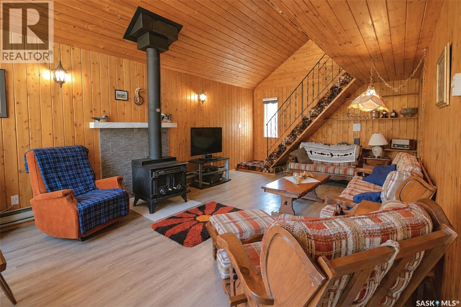 303 Christel Crescent, Lac Des Îles, SK - Indoor Photo Showing Other Room With Fireplace