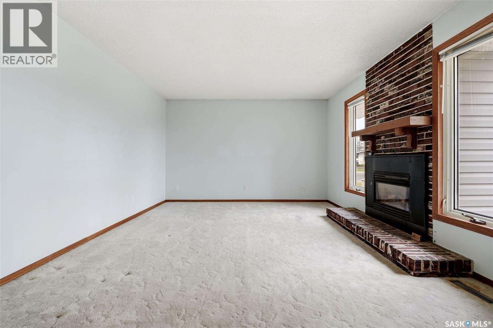 65 Mccaul Crescent, Regina, SK - Indoor Photo Showing Other Room With Fireplace