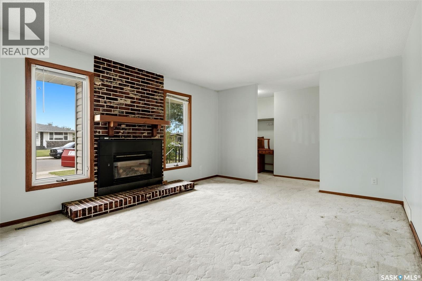 65 Mccaul Crescent, Regina, SK - Indoor Photo Showing Other Room With Fireplace