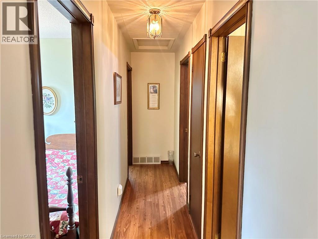 Hallway with laminate -finish flooring, recessed lighting, and a neutral color palette - 44 Douglas Avenue, Simcoe, ON - Indoor Photo Showing Other Room