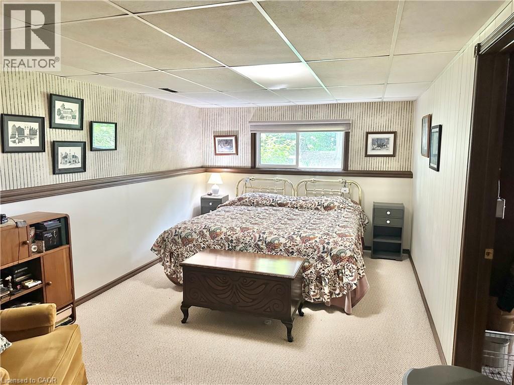 Bedroom --Lower Level - Wall-to-wall carpeting and wainscoting with a dark wood trim accent - 44 Douglas Avenue, Simcoe, ON - Indoor Photo Showing Bedroom