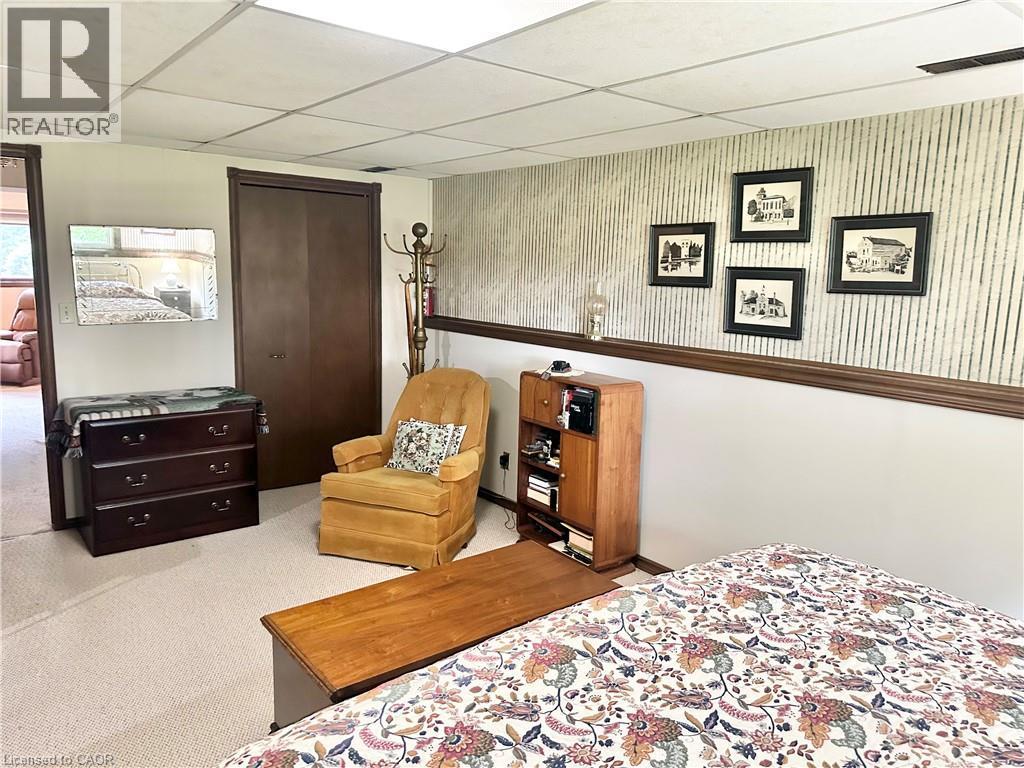Bedroom - lower level -Recessed ceiling, neutral carpet, wood-finish trim, and closet with bifold doors - 44 Douglas Avenue, Simcoe, ON - Indoor Photo Showing Bedroom