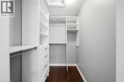 Custom white built-in closet system with shelving and drawers - 