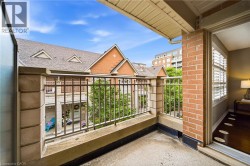 Private balcony featuring a metal railing and brick exterior - 