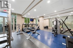 Fitness facility with resilient flooring, recessed lighting, and expansive windows - 