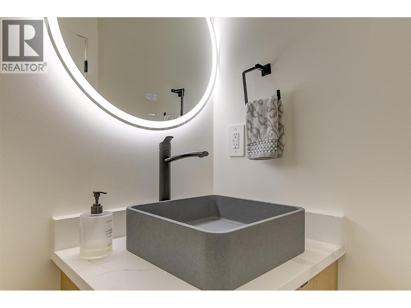 Stone vessel sink • backlit mirror - 747 Patterson Avenue Unit# 2, Kelowna, BC - Indoor Photo Showing Other Room