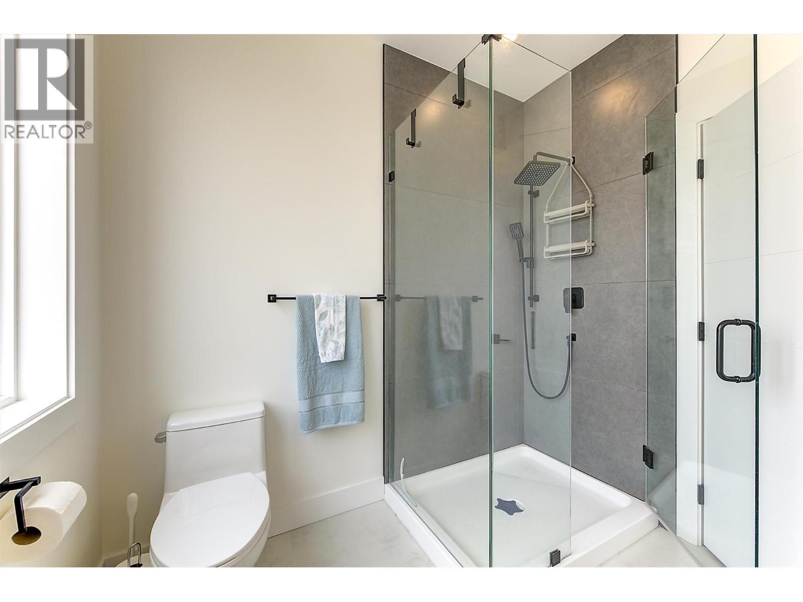 Glass shower • rainfall showerhead - 747 Patterson Avenue Unit# 2, Kelowna, BC - Indoor Photo Showing Bathroom
