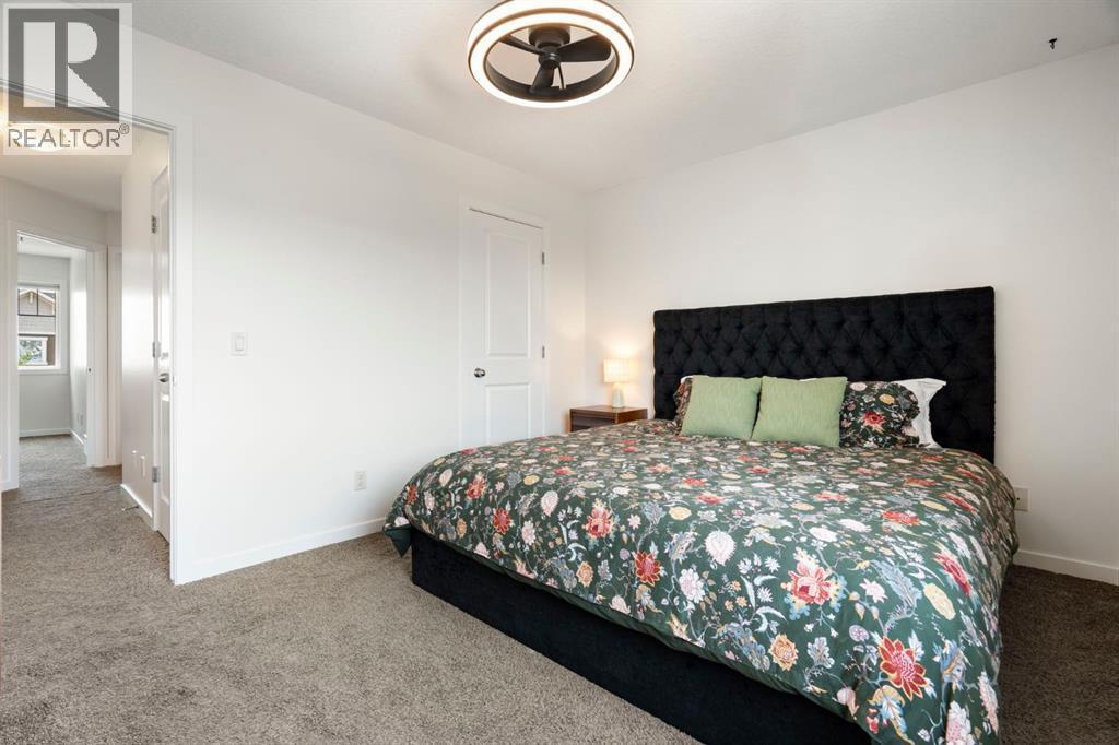 12 Fireside Burrow, Cochrane, AB - Indoor Photo Showing Bedroom