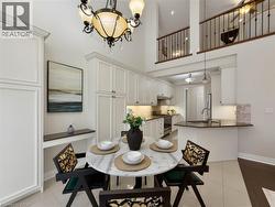Two-story living area with a loft and wrought iron railing - 