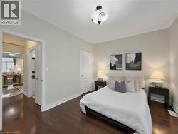 Hardwood flooring, crown molding, white trim, recessed lighting in the hall, and a decorative ceiling fixture - 