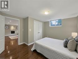 Wood-finish flooring throughout, double panel doors, and a window providing natural light - 