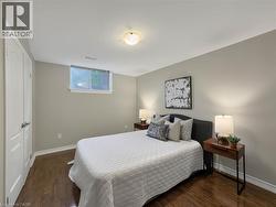 Wood-finish flooring, neutral wall tones, and a window with natural light - 