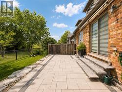 Expansive brick exterior with a stone paver patio - 