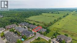 Residential community bordering expansive green fields and mature tree lines - 