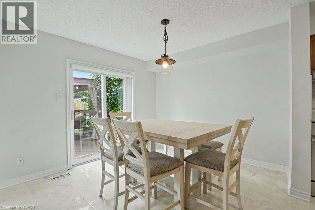 Sliding glass door to rear yard/outdoor patio area - 568 Robert Ferrie Drive, Kitchener, ON - Indoor Photo Showing Dining Room