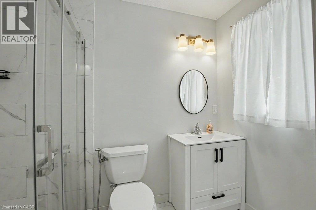 Ensuite bathroom with glass-enclosed shower and beautiful ceramic wall tiles - 568 Robert Ferrie Drive, Kitchener, ON - Indoor Photo Showing Bathroom