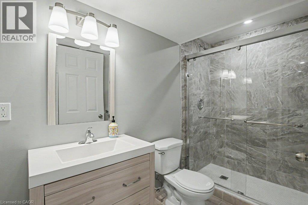 Basement bathroom with modern vanity/sink and glass enclosed tile finished shower - 568 Robert Ferrie Drive, Kitchener, ON - Indoor Photo Showing Bathroom