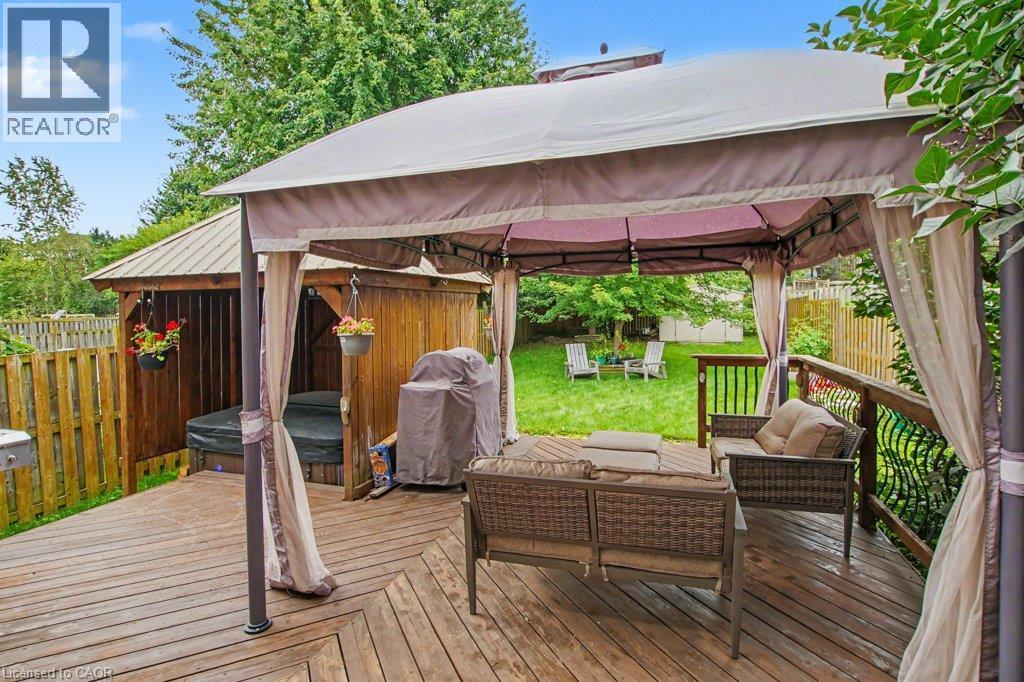 Expansive wood deck with a built-in gazebo, privacy curtains, and wooden privacy fence - 568 Robert Ferrie Drive, Kitchener, ON - Outdoor With Deck Patio Veranda With Exterior