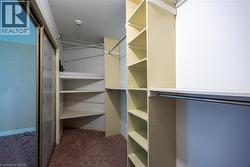 Custom closet system featuring multiple shelving units and clothing rods - 
