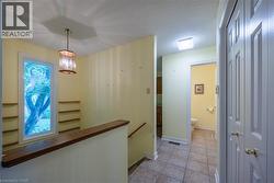 Staircase landing to the Basement  by the Garage entry, Mud Room and 2 Piece Bathroom - 