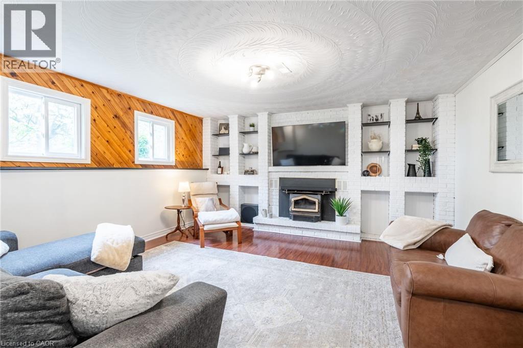 White brick fireplace with an integrated wood-burning insert - 152 Concession 7 Road E, Millgrove, ON - Indoor Photo Showing Living Room With Fireplace