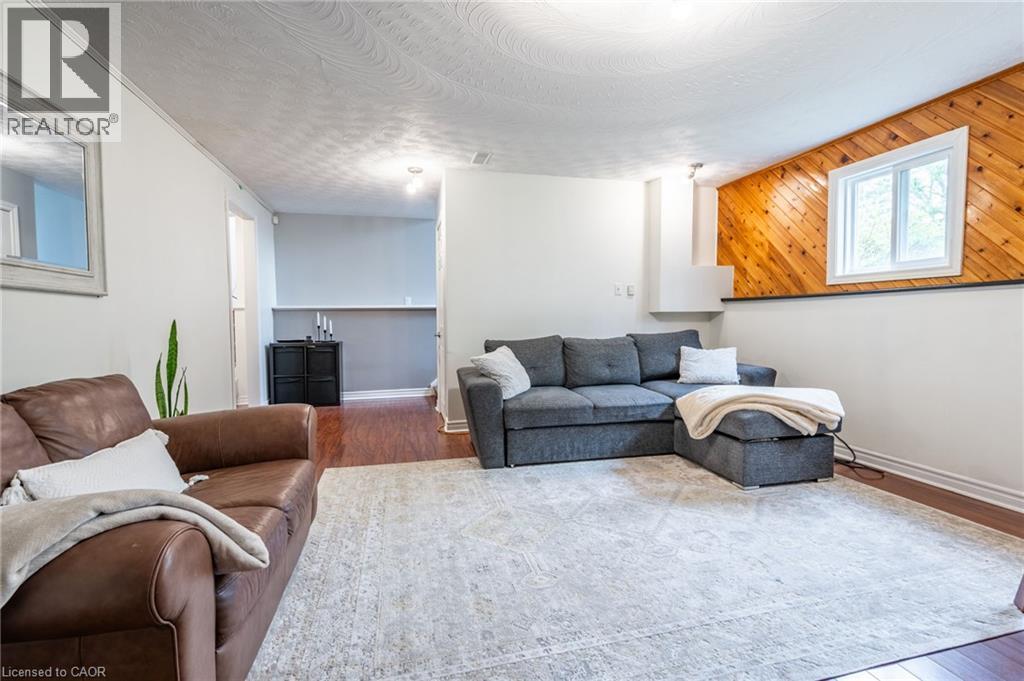Wood-finish flooring, white walls, and a recessed window with wood-paneled detailing - 152 Concession 7 Road E, Millgrove, ON - Indoor Photo Showing Living Room