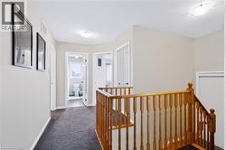 Hallway featuring carpeted flooring and light-toned walls - 