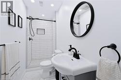 Shower with white subway tile surround, integrated niche, and clear glass enclosure - 
