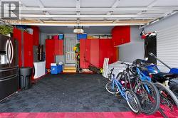 Garage interior with modular flooring and extensive built-in red cabinetry - 