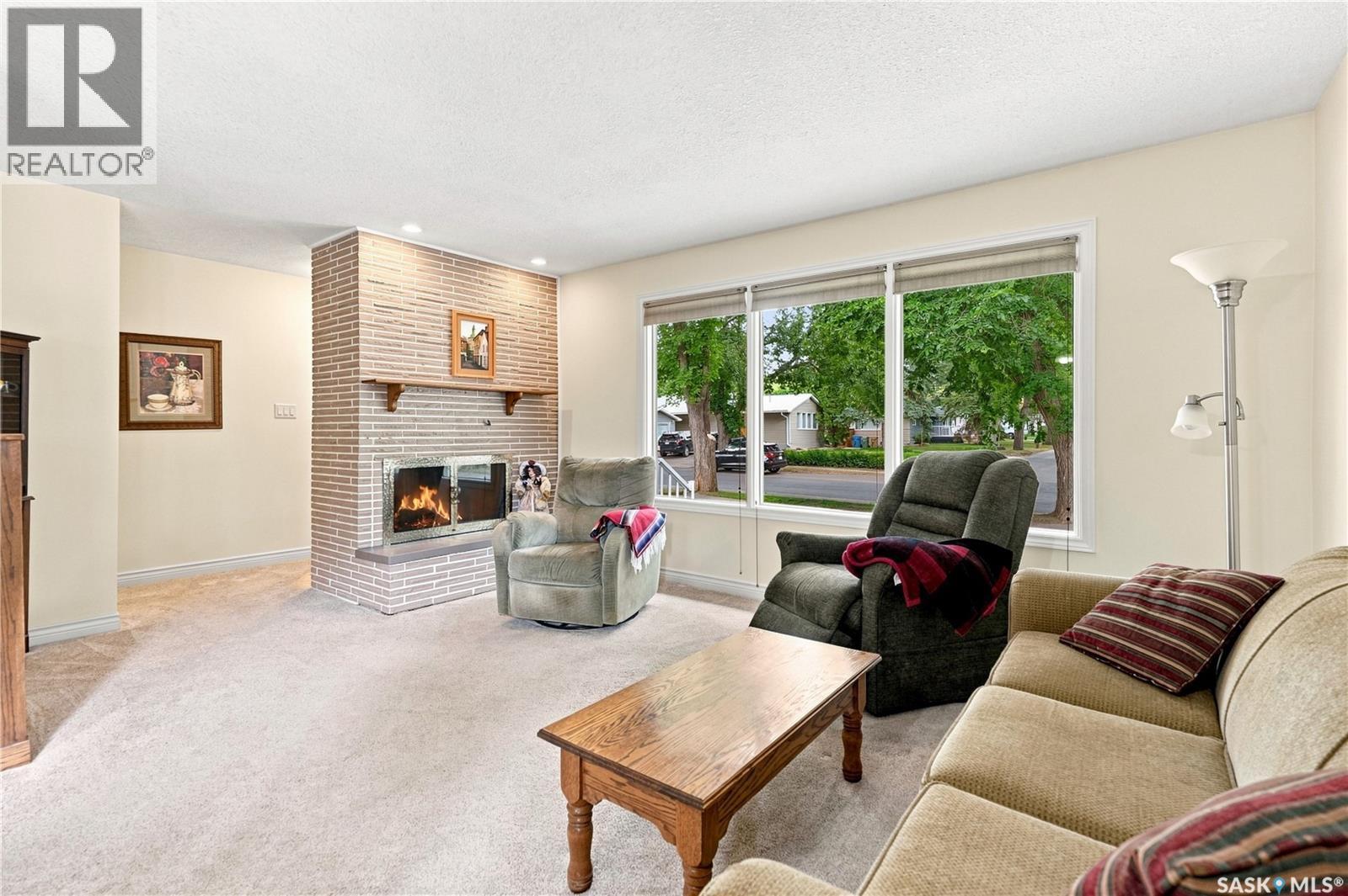 220 Frontenac Drive, Regina, SK - Indoor Photo Showing Living Room With Fireplace