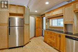 Door to rear foyer is off the kitchen. - 