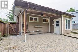 Covered brick patio;  pot lights & a ceiling fan. - 