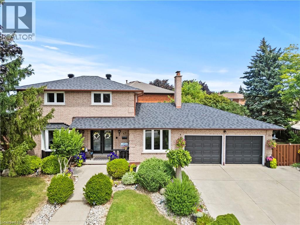 Brick exterior with a double-door entry, a two-car garage, and a concrete driveway - 87 Monte Drive, Hamilton, ON - Outdoor