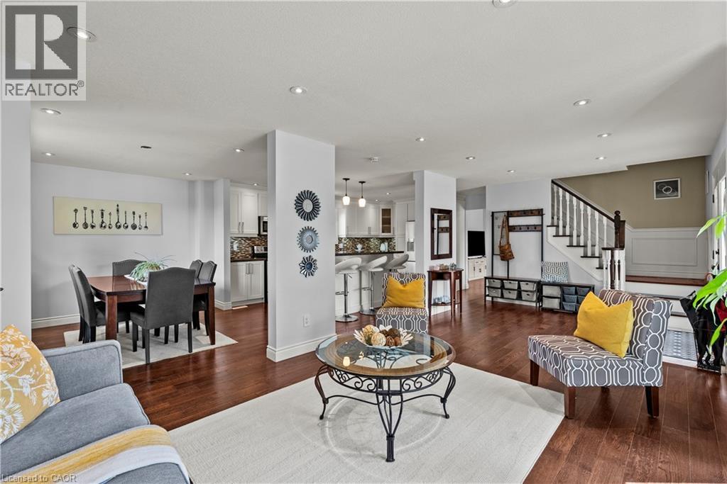 Recessed lighting illuminates wood-finish flooring throughout the open-concept space - 87 Monte Drive, Hamilton, ON - Indoor Photo Showing Living Room