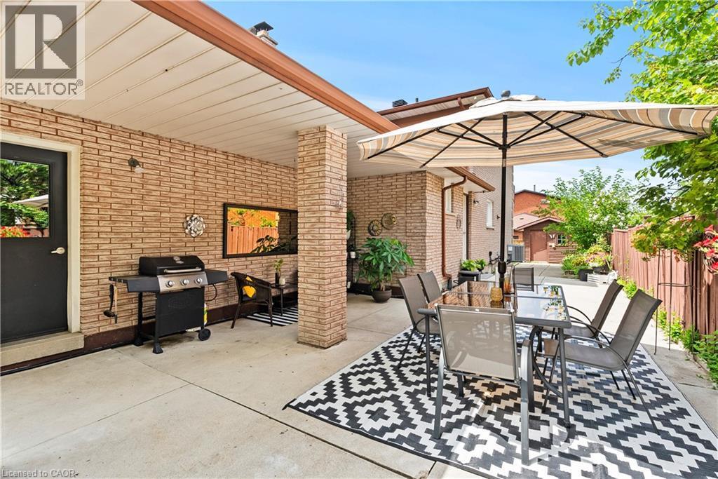 Covered patio featuring brick exterior walls and a concrete surface - 87 Monte Drive, Hamilton, ON - Outdoor With Deck Patio Veranda With Exterior