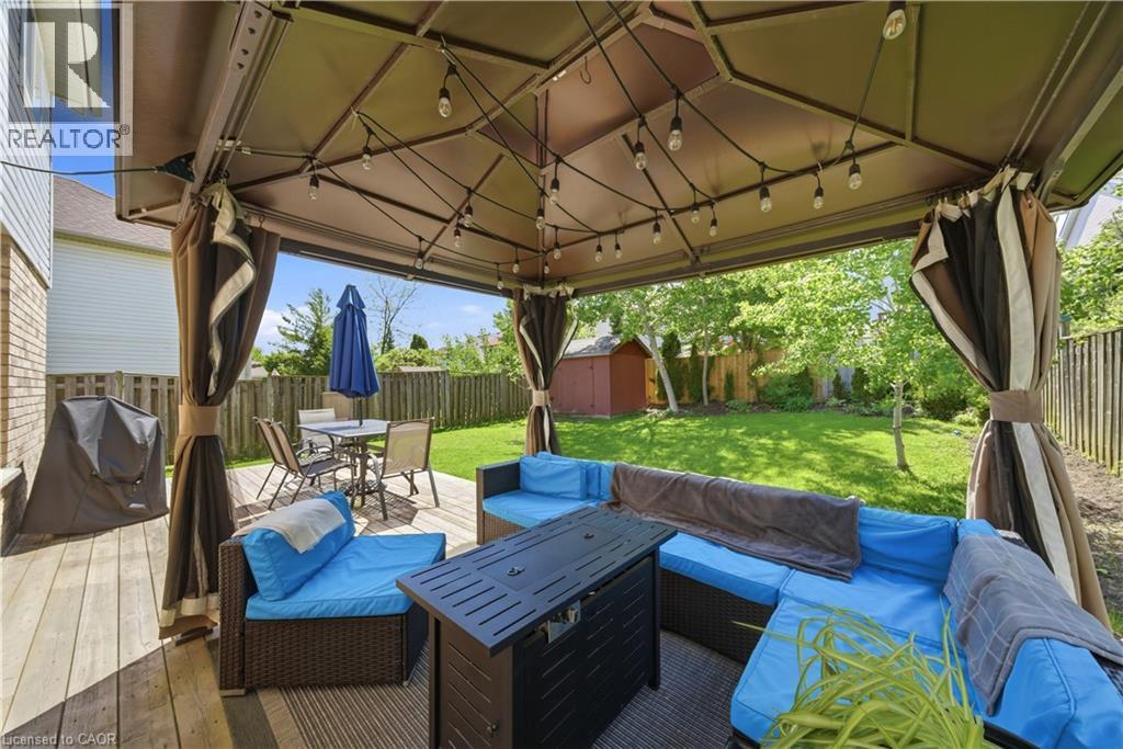 Spacious outdoor deck featuring a large gazebo with string lighting, privacy curtains, and a built-in outdoor kitchen area - 784 Butternut Avenue, Waterloo, ON - Outdoor With Deck Patio Veranda With Exterior
