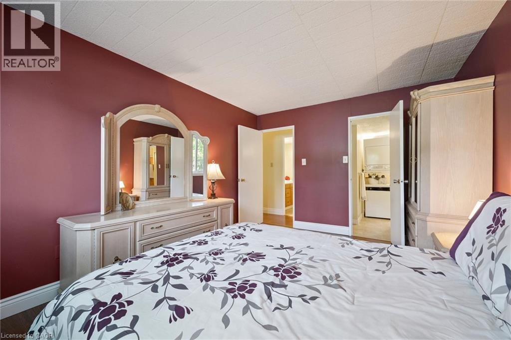 Hardwood-style flooring throughout, with a neutral ceiling - 6 Walton Avenue Unit# 107, Kitchener, ON - Indoor Photo Showing Bedroom