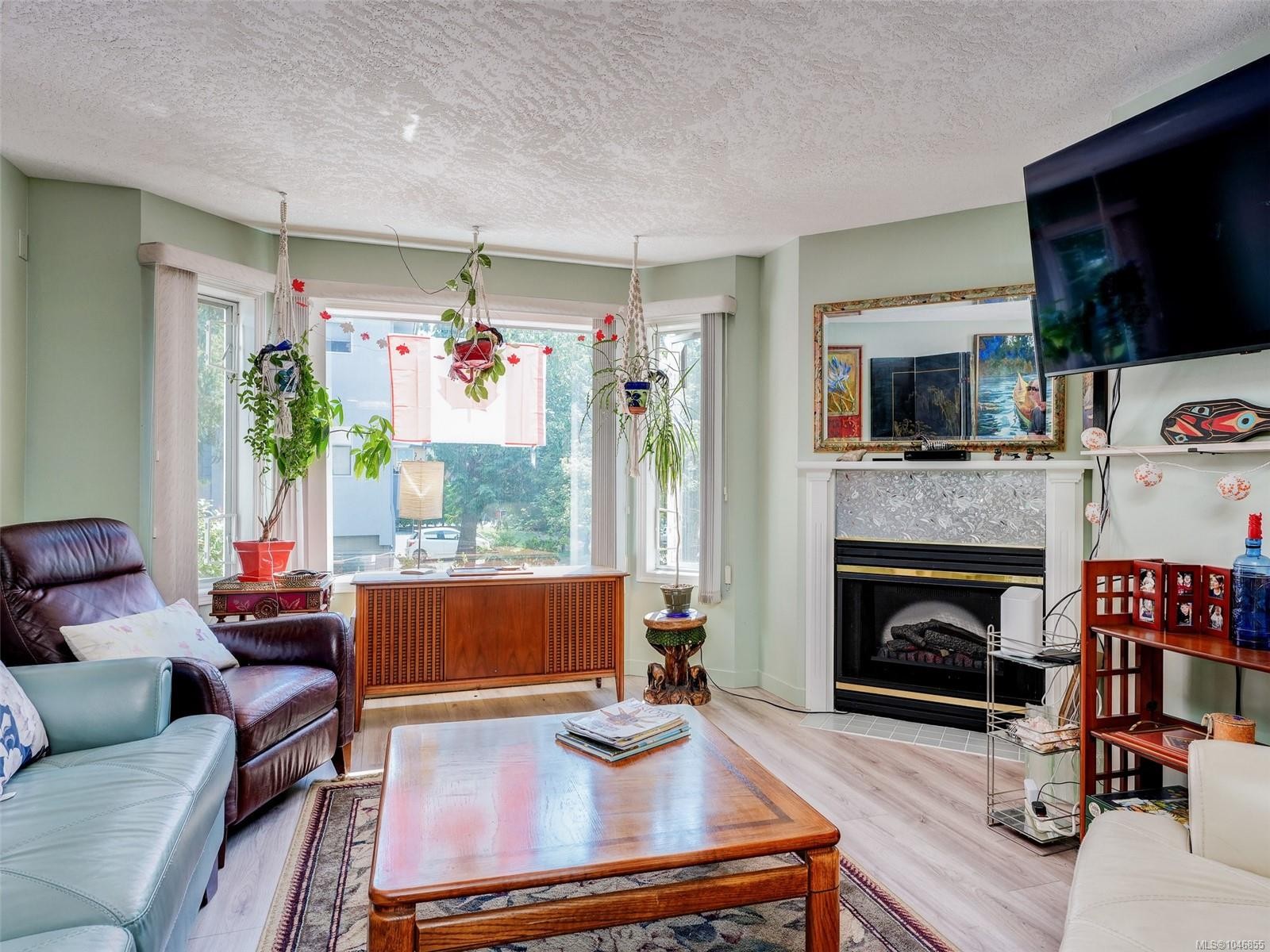 #208-9882 Fifth St, Sidney, BC - Indoor Photo Showing Living Room With Fireplace