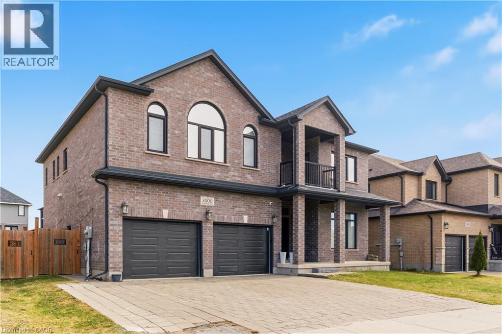 Striking brick exterior with arched windows and a modern architectural design - 2000 Maddex Way, London, ON - Outdoor