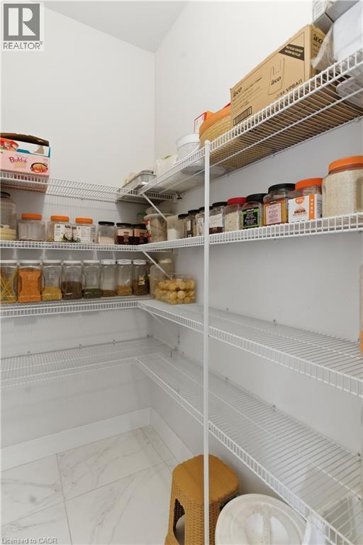 Organized pantry featuring multiple wire shelving units with ample storage capacity for dry goods and pantry staples - 2000 Maddex Way, London, ON - Indoor With Storage