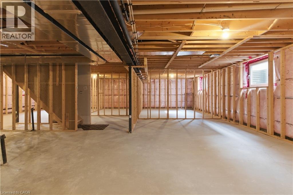Expansive unfinished basement with concrete flooring, exposed wood-frame framing, and recessed ceiling lighting - 2000 Maddex Way, London, ON - Indoor Photo Showing Basement