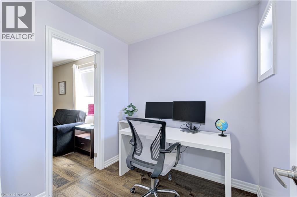 Interior room with wood-finish flooring, light-toned walls, and a white baseboard trim - 1406 Marshall Crescent, Milton, ON - Indoor Photo Showing Office