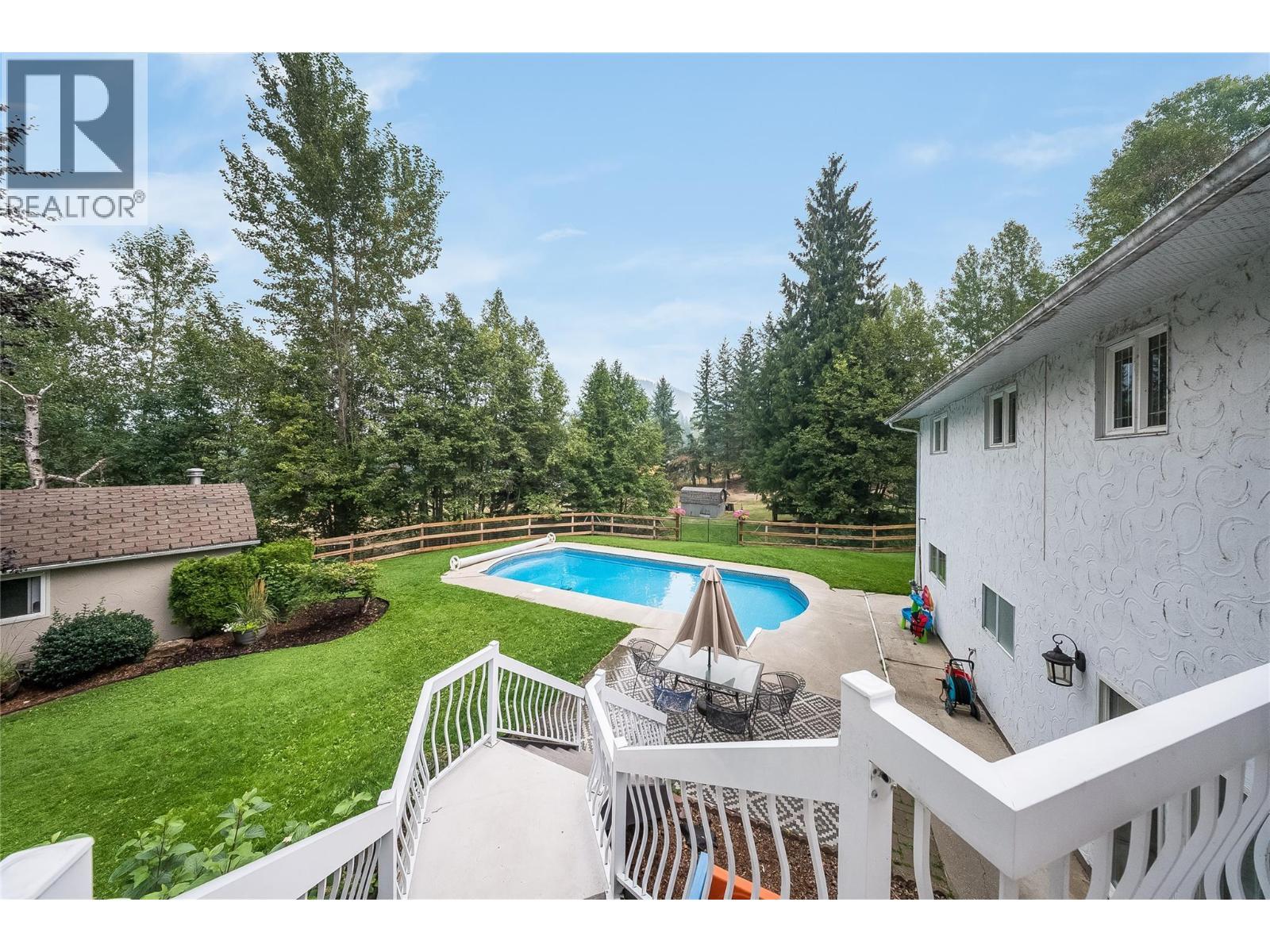 314 Webster Road, Fruitvale, BC - Outdoor With In Ground Pool With Deck Patio Veranda With Backyard