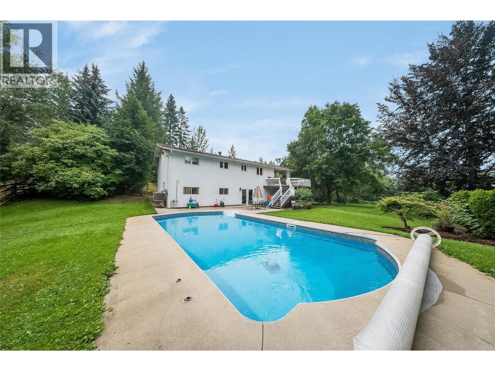 314 Webster Road, Fruitvale, BC - Outdoor With In Ground Pool With Backyard