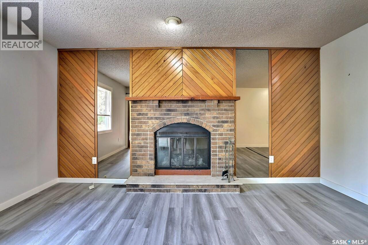 122 Edenwold Crescent, Regina, SK - Indoor Photo Showing Living Room With Fireplace