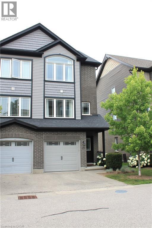 Multi-level facade featuring varied grey siding and brick accents - 12 Poplar Drive Unit# 21, Cambridge, ON - Outdoor