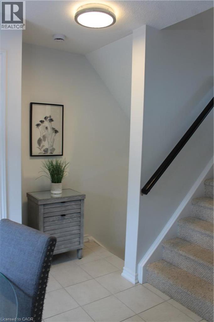 Recessed ceiling light, tiled flooring, carpeted stairs, and a dark handrail - 12 Poplar Drive Unit# 21, Cambridge, ON - Indoor Photo Showing Other Room