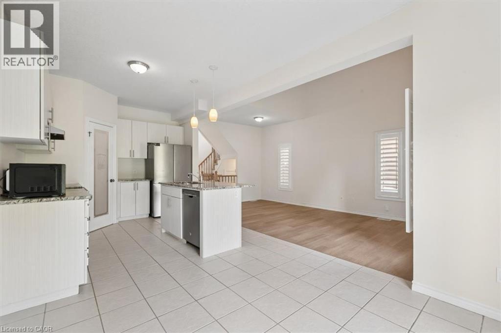 Kitchen featuring white cabinetry, stainless steel appliances, a center island with a sink, and pendant lighting - 242 Moorlands Crescent, Kitchener, ON - Indoor Photo Showing Kitchen