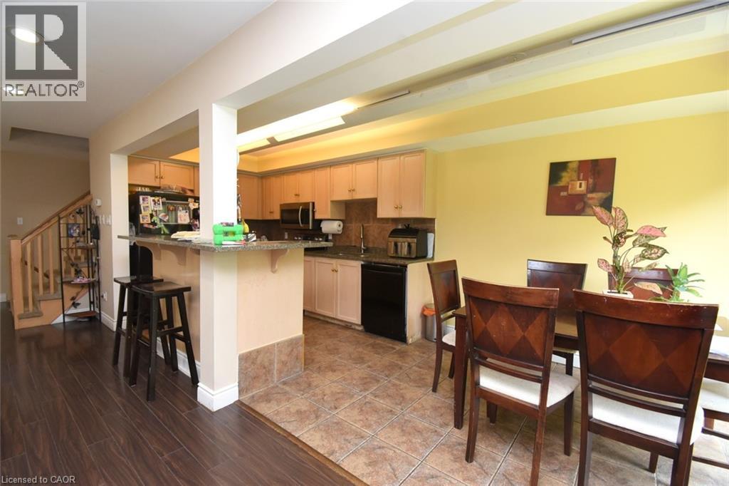 Kitchen featuring light wood-finish cabinetry, black appliances, and a tiled backsplash - 509 Southridge Drive, Hamilton, ON - Indoor