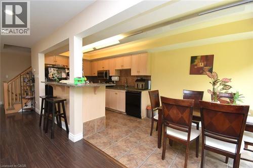Kitchen featuring light wood-finish cabinetry, black appliances, and a tiled backsplash - 509 Southridge Drive, Hamilton, ON - Indoor
